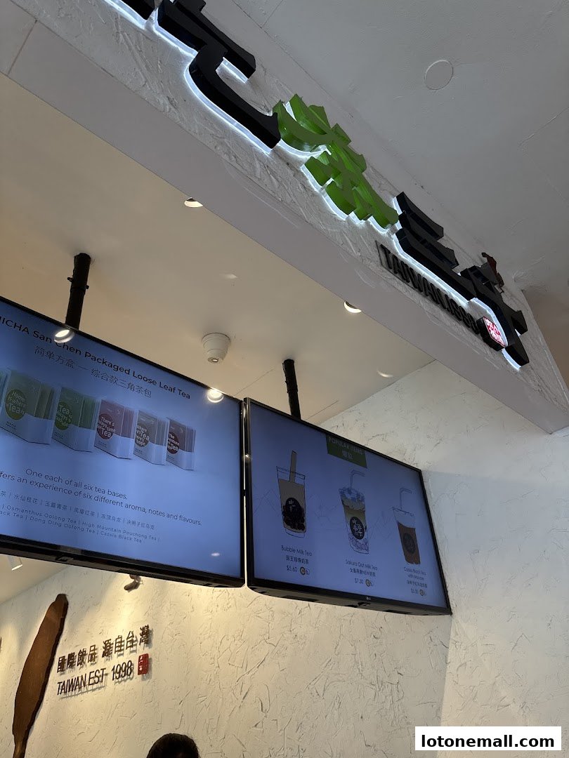 A view of the CHICHA San Chen shop interior, showcasing their logo and digital menus.