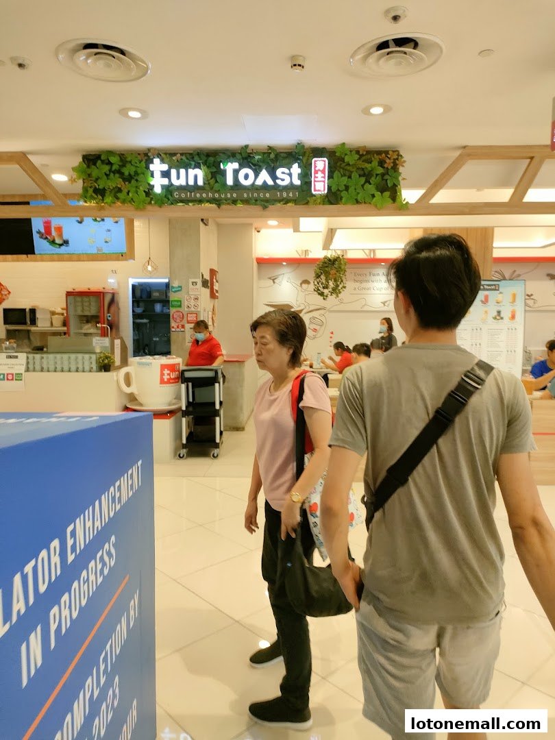 The Fun Toast coffeehouse entrance with people walking by.