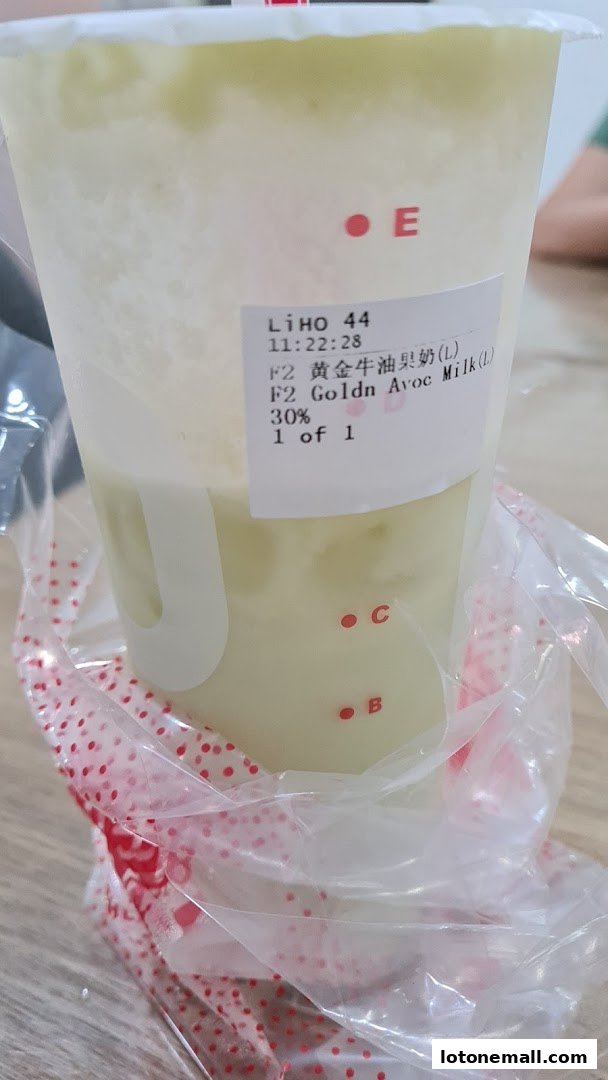 A close-up of a LiHO TEA cup with a label showing a drink order.