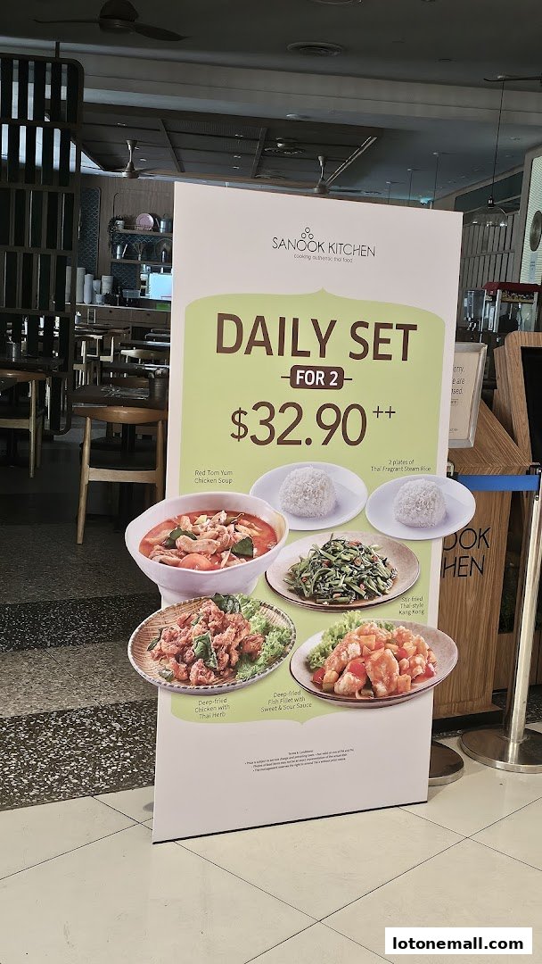 A promotional sign for Sanook Kitchen's 'Daily Set for 2' featuring Thai dishes.