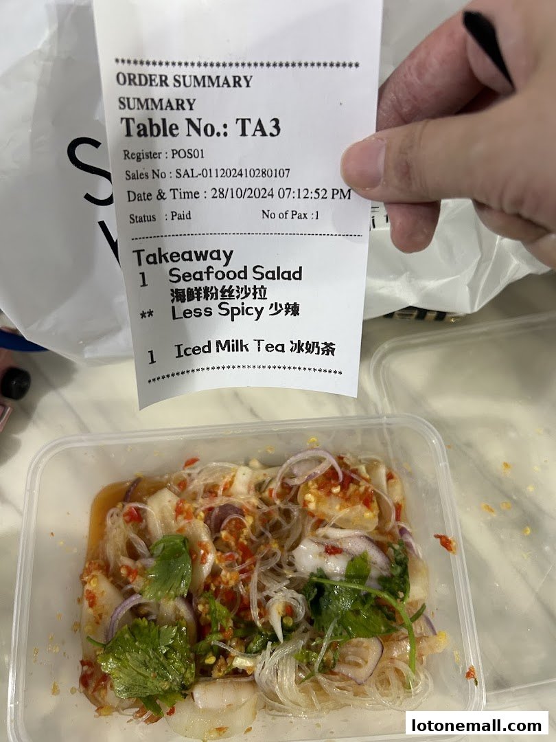 A receipt and a takeaway container of seafood salad from Sanook Kitchen.
