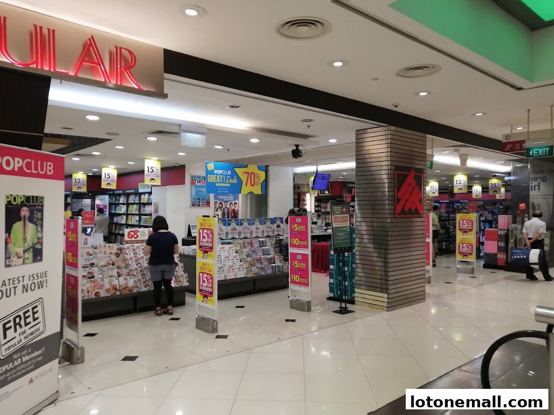 The entrance of a POPULAR Bookstore with displays of books, magazines, and promotional signs.