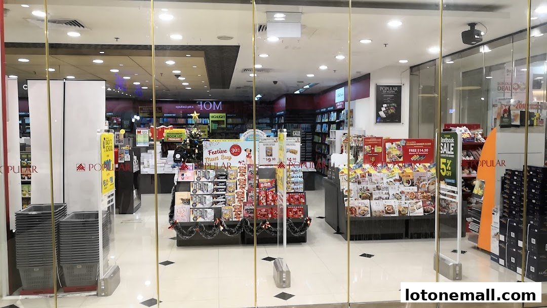 The entrance of a POPULAR Bookstore, showcasing books, stationery, and festive displays.