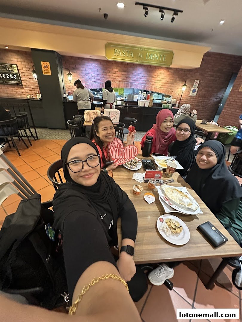 A group of friends enjoys a meal at PastaMania, celebrating Valentine's Day.