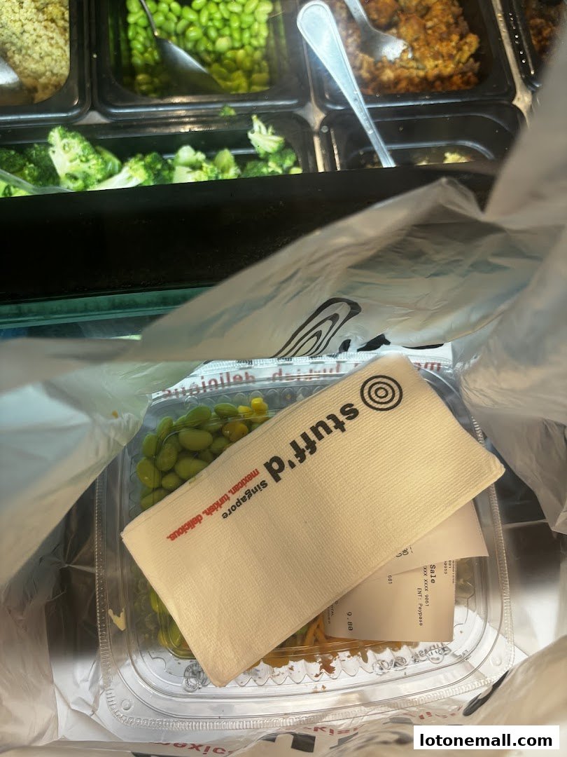 A takeout bag from Stuff'd with a meal and a receipt inside.