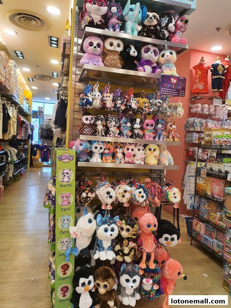 A wide selection of colorful plush toys displayed on shelves and racks inside a store.