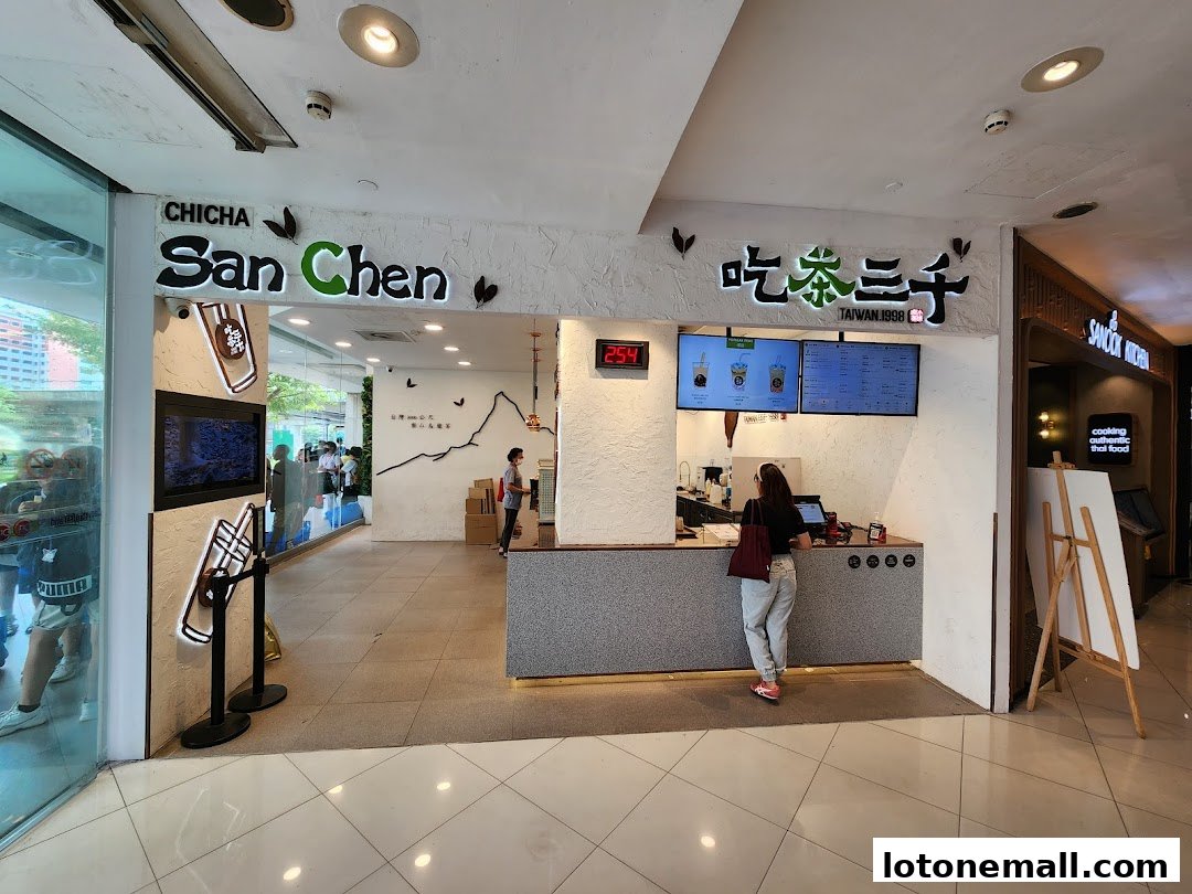 A customer orders at the counter of a CHICHA San Chen bubble tea shop.