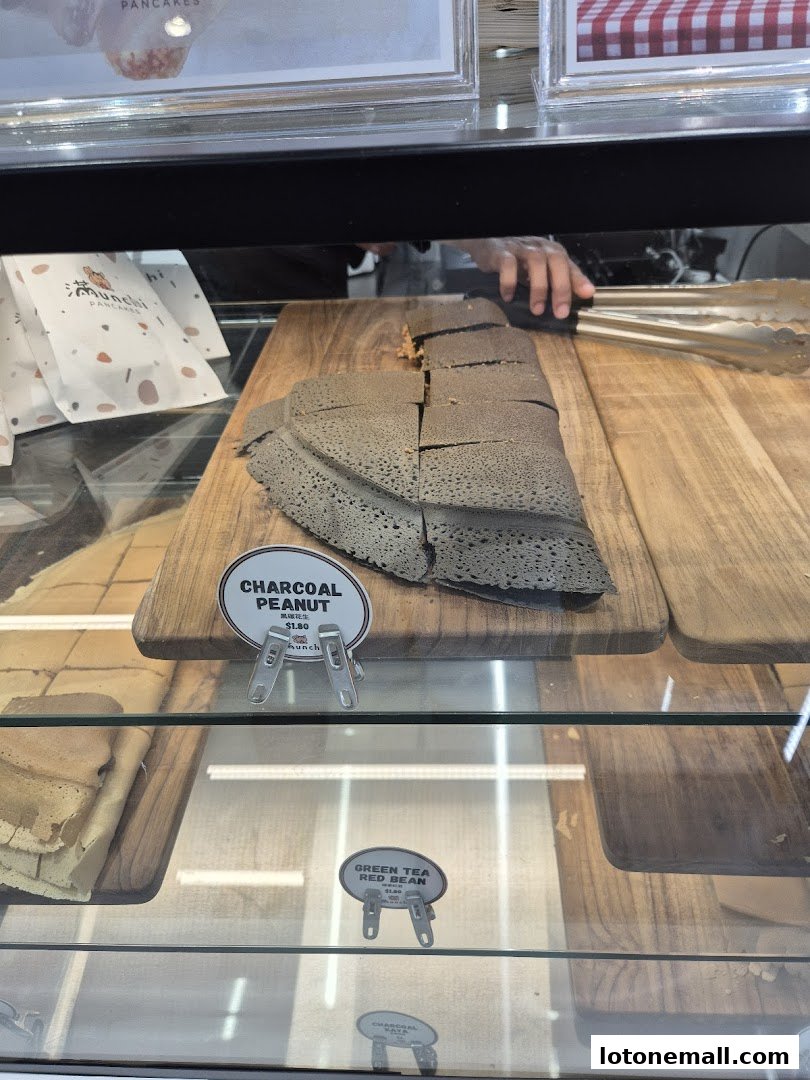 A display case showcasing charcoal peanut pancakes and green tea red bean pancakes.