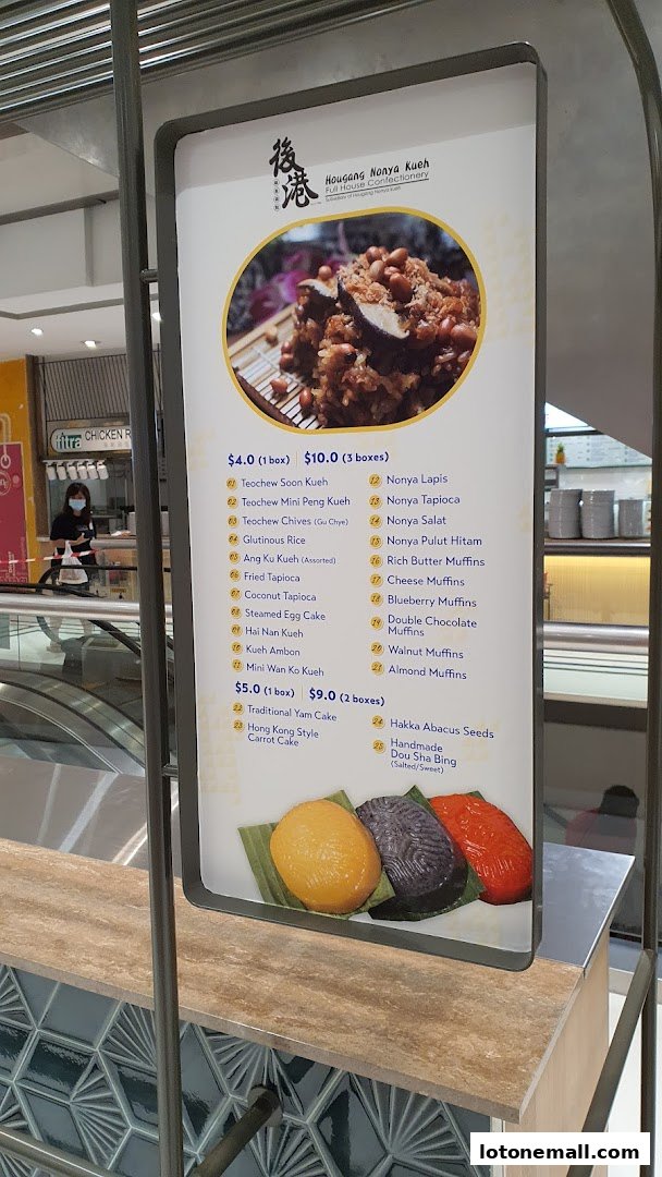 A menu board for Hougang Nonya Kueh displaying various traditional kueh and muffins with prices.