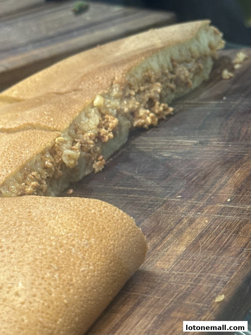 A close-up shot of a delicious, thick pancake filled with a sweet, nutty mixture.