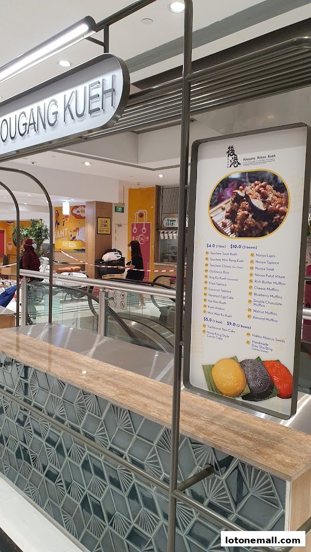 A menu board for Hougang Kueh, displaying various kueh and muffin options with prices.