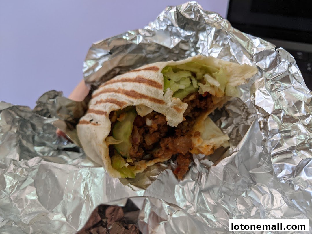 A close-up shot of a delicious wrap from Stuffd, wrapped in foil.