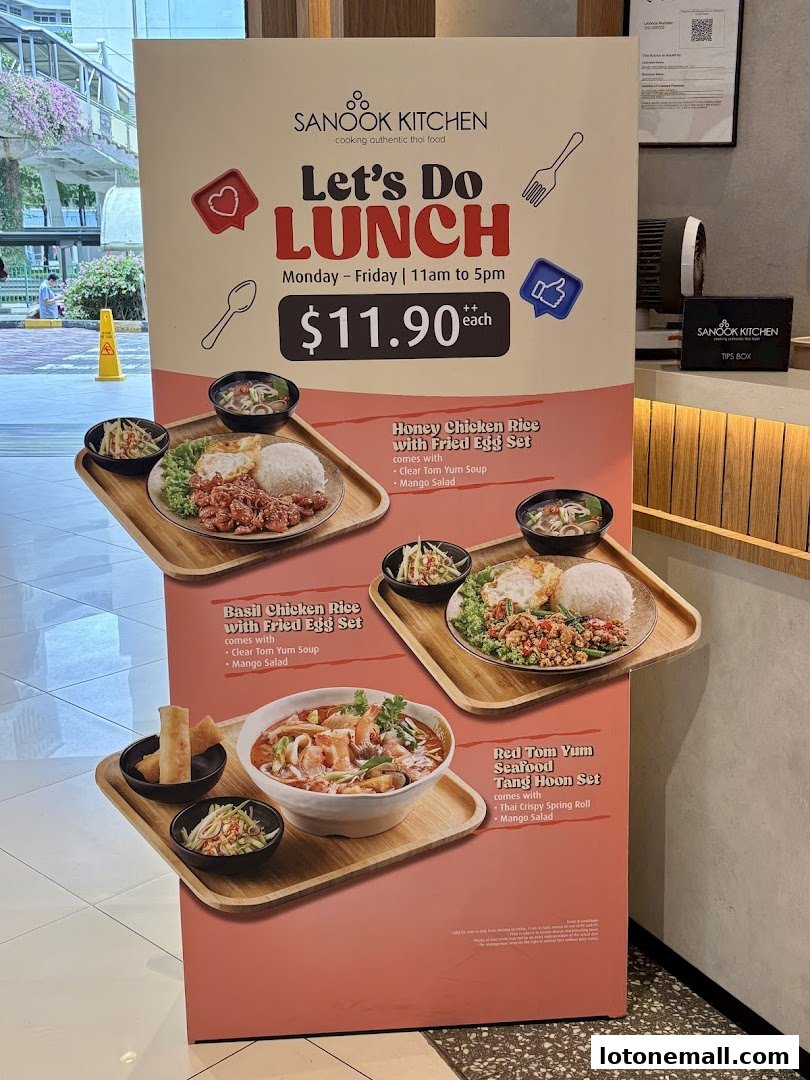 A promotional sign for Sanook Kitchen's lunch sets, featuring three Thai meal options.