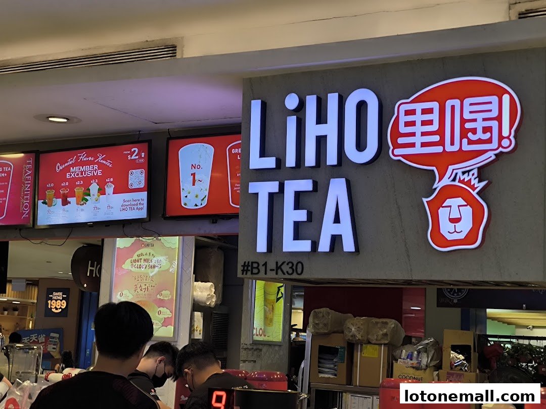 The LiHO TEA shop front with illuminated signage and digital menu displays.
