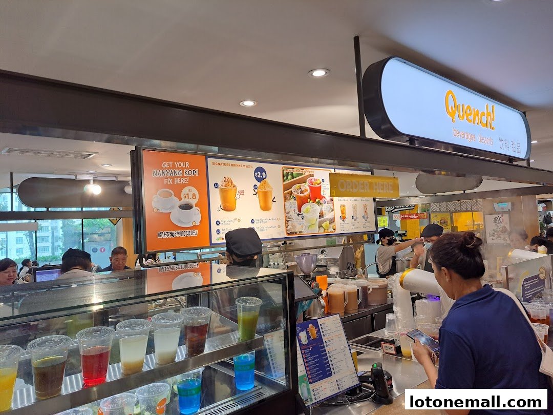 A food court counter with various drinks displayed and a menu board showing signature drinks.