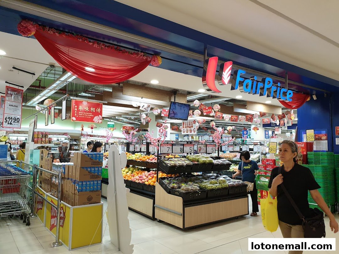 Interior view of a FairPrice supermarket with fresh produce and shoppers.