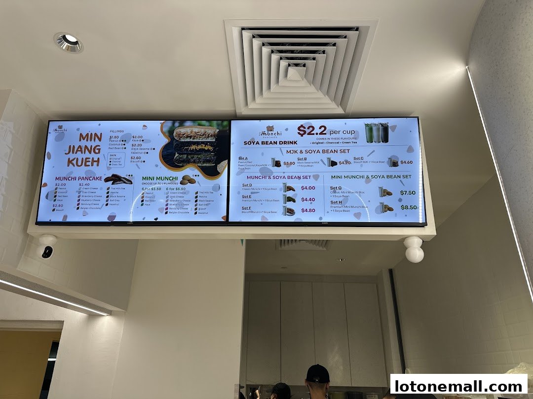 A digital menu board displaying various pancake and soya bean drink options with prices.