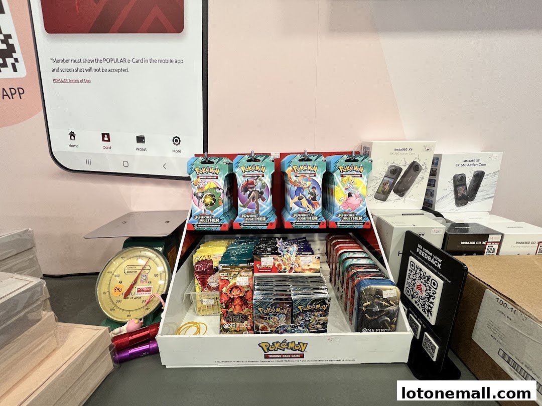Display of Pokemon trading cards and Insta360 cameras at POPULAR Bookstore.