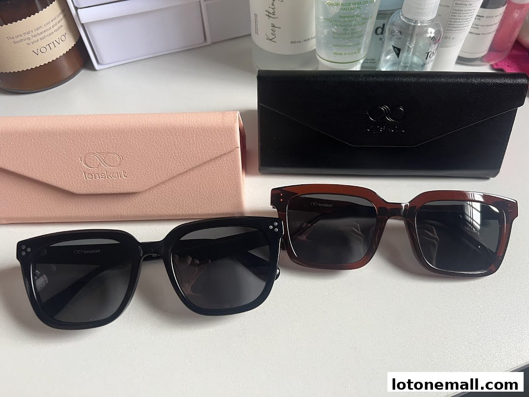 Two pairs of Lenskart sunglasses with their cases, alongside skincare products.