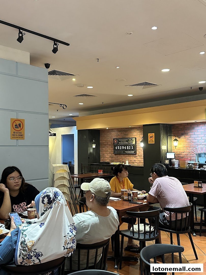 Diners are seated at tables inside PastaMania, an Italian casual dining restaurant.