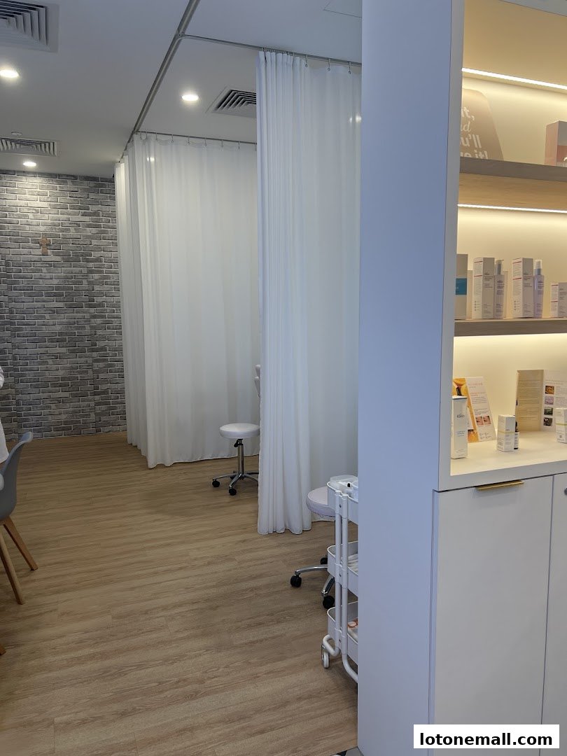 Interior view of a clean and modern facial treatment salon with treatment rooms and product displays.