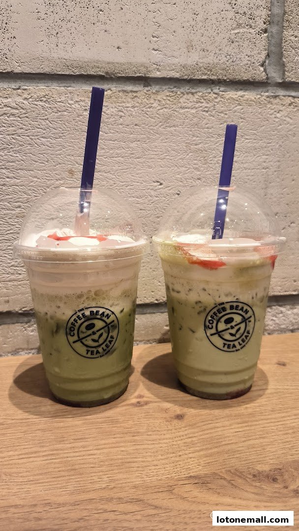 Two iced matcha drinks with whipped cream and strawberry drizzle from The Coffee Bean & Tea Leaf.