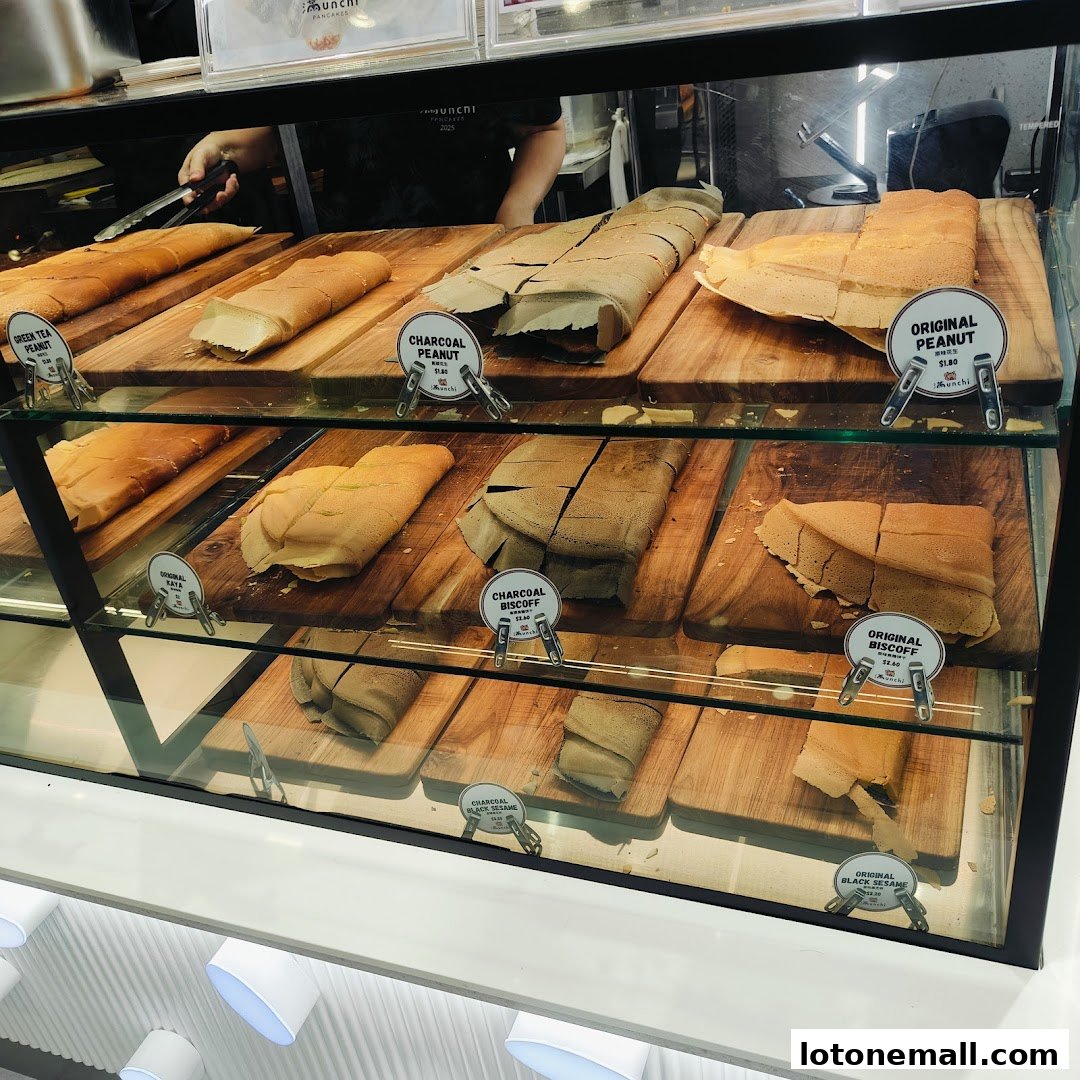 A display case filled with various flavors of freshly made pancakes.