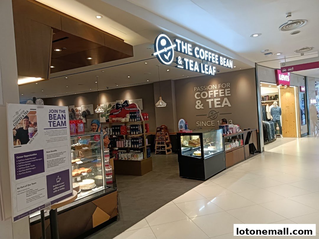 The Coffee Bean & Tea Leaf shop front with a display of pastries and a recruitment poster.