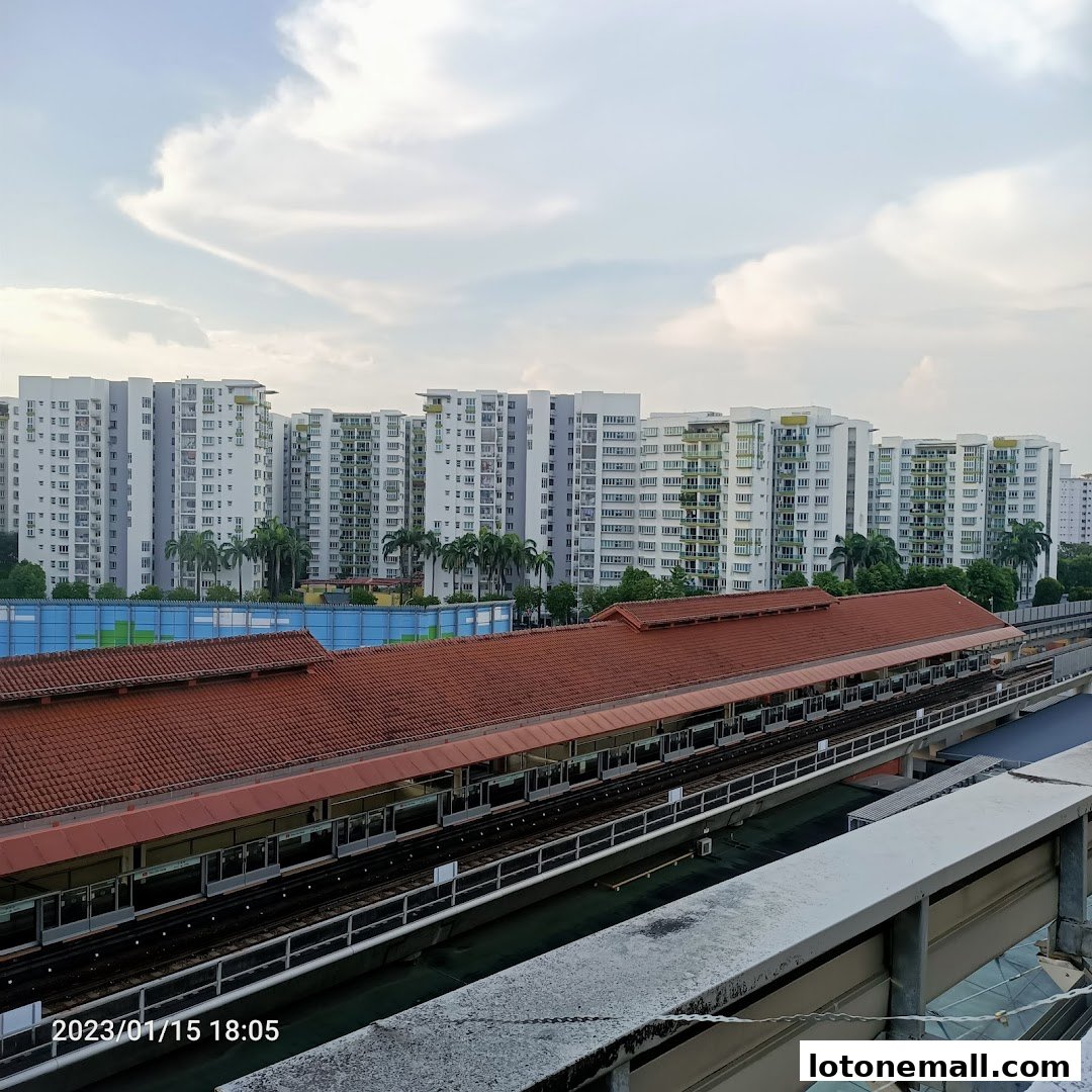 A view of apartment buildings and a train station with a red-tiled roof.