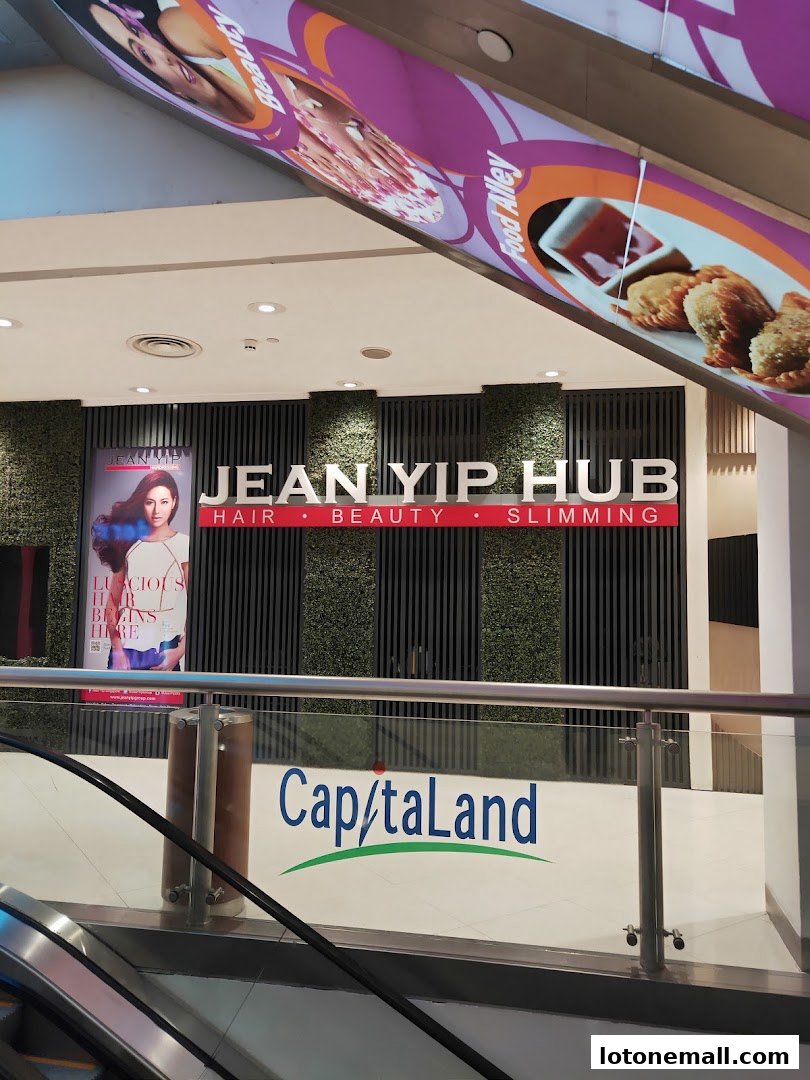 The Jean Yip Hub salon entrance with its prominent signage and a poster advertising hair services.