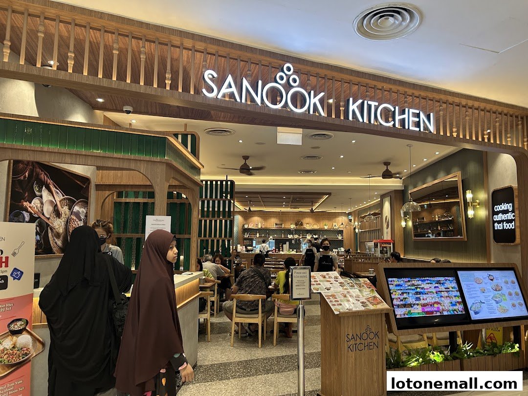The exterior of Sanook Kitchen, a Thai restaurant, with its prominent signage and inviting interior.