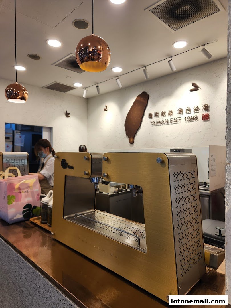 Interior of a CHICHA San Chen shop with a tea-making machine and a Taiwan map.