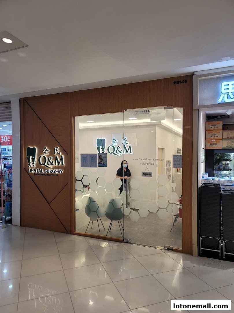 The entrance to Q&M Dental Surgery, a modern clinic with a glass door and interior seating.