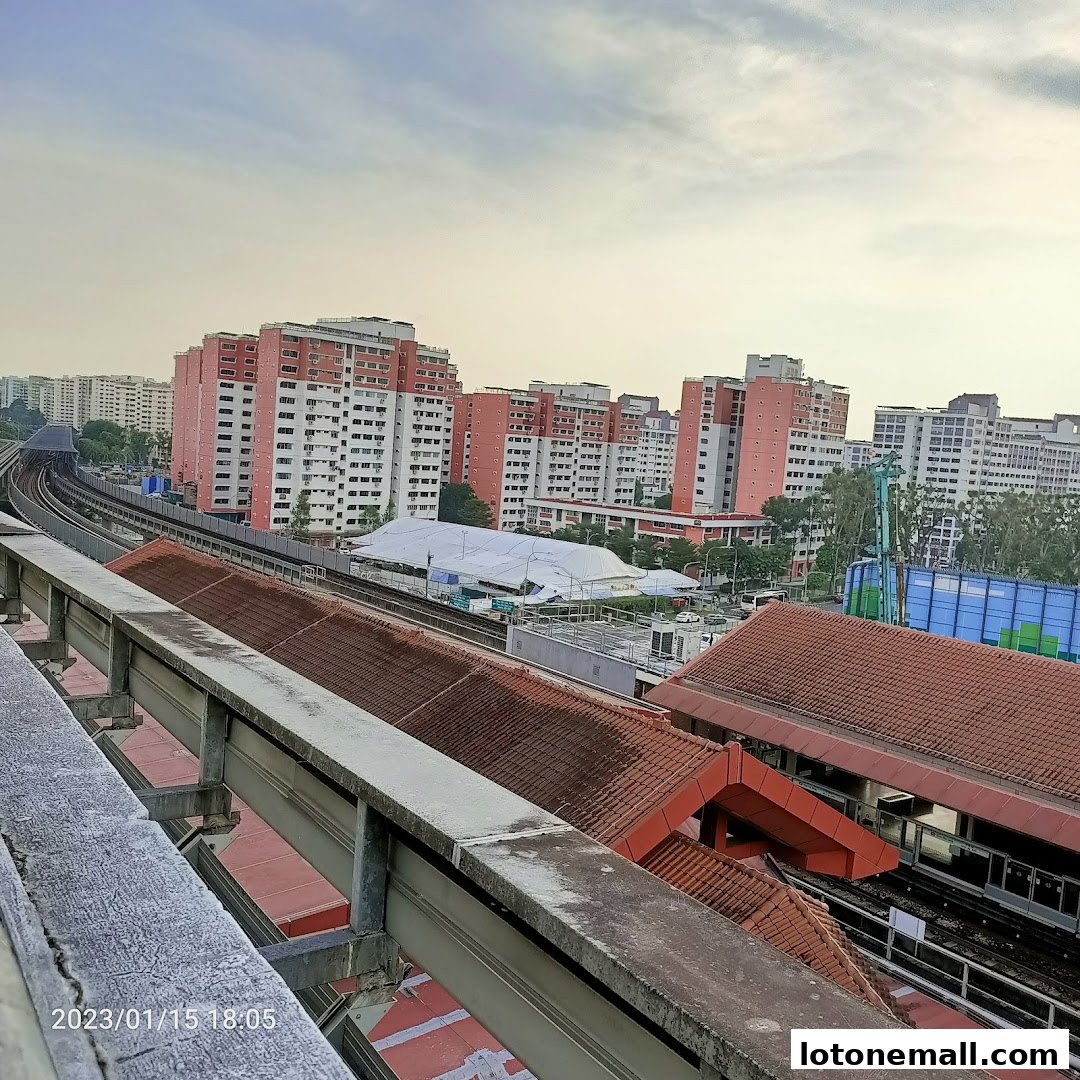 An elevated view of a cityscape with apartment buildings and train tracks.