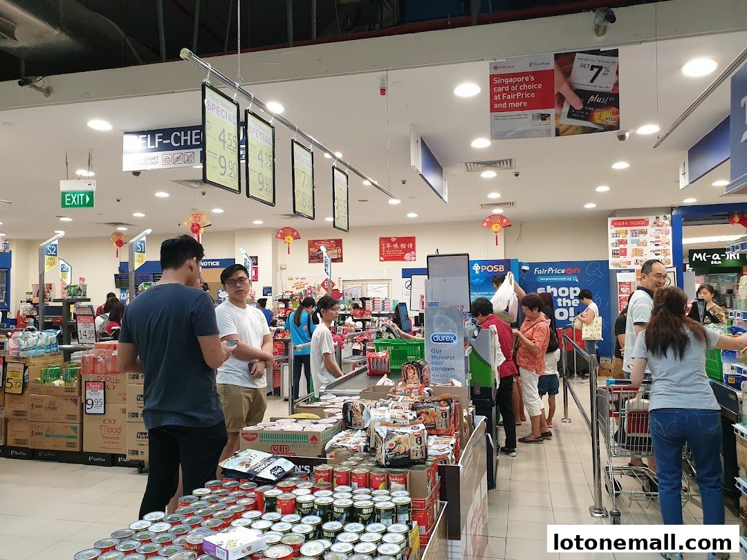 People shopping at a FairPrice supermarket with promotional signs and displays.