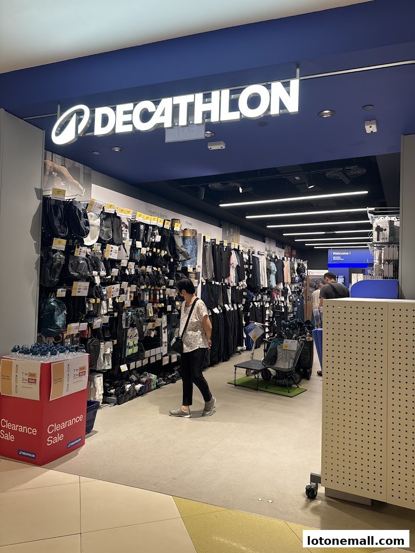 Interior view of a Decathlon store with sports apparel and accessories displayed.