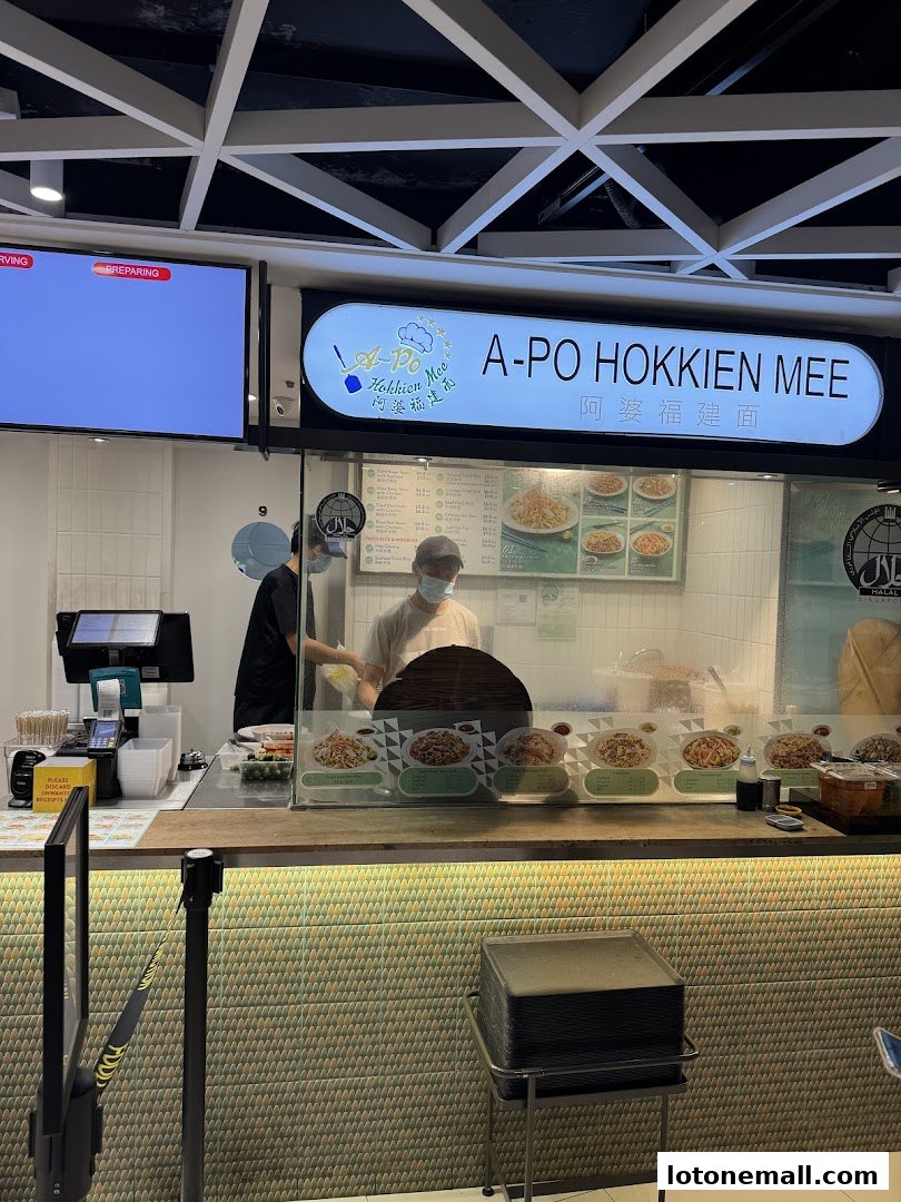 A-Po Hokkien Mee food stall with staff preparing food behind the counter.