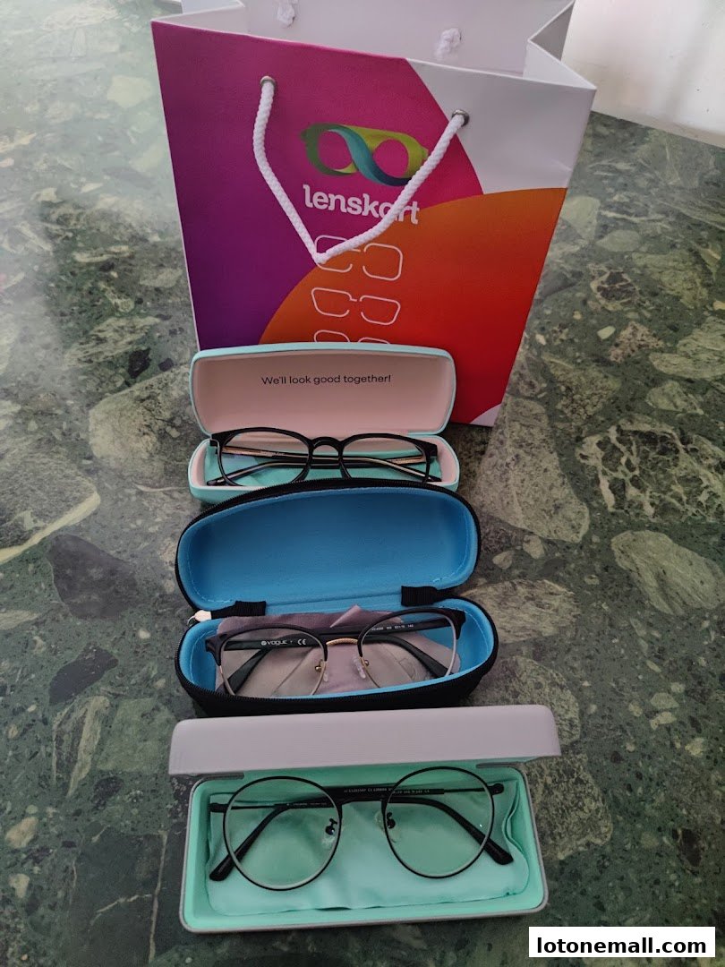 A Lenskart shopping bag and three pairs of eyeglasses in cases.