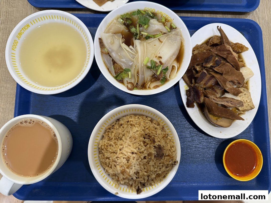 A tray of food from Food Junction Food Court, including rice, soup, noodles, and meat.