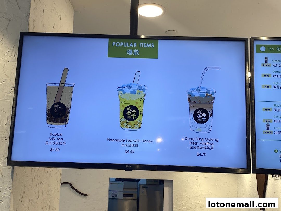 A digital menu board displaying popular bubble tea drinks with illustrations and prices.