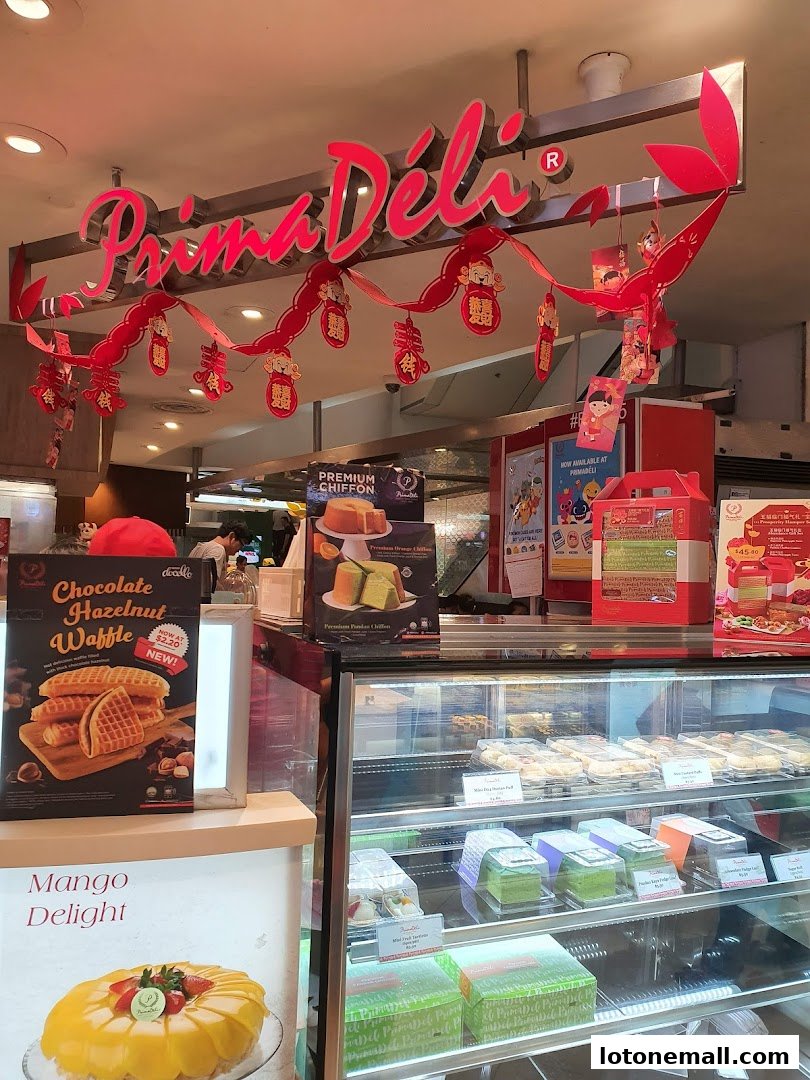 A display of cakes and pastries at Prima Deli, decorated for a festive occasion.