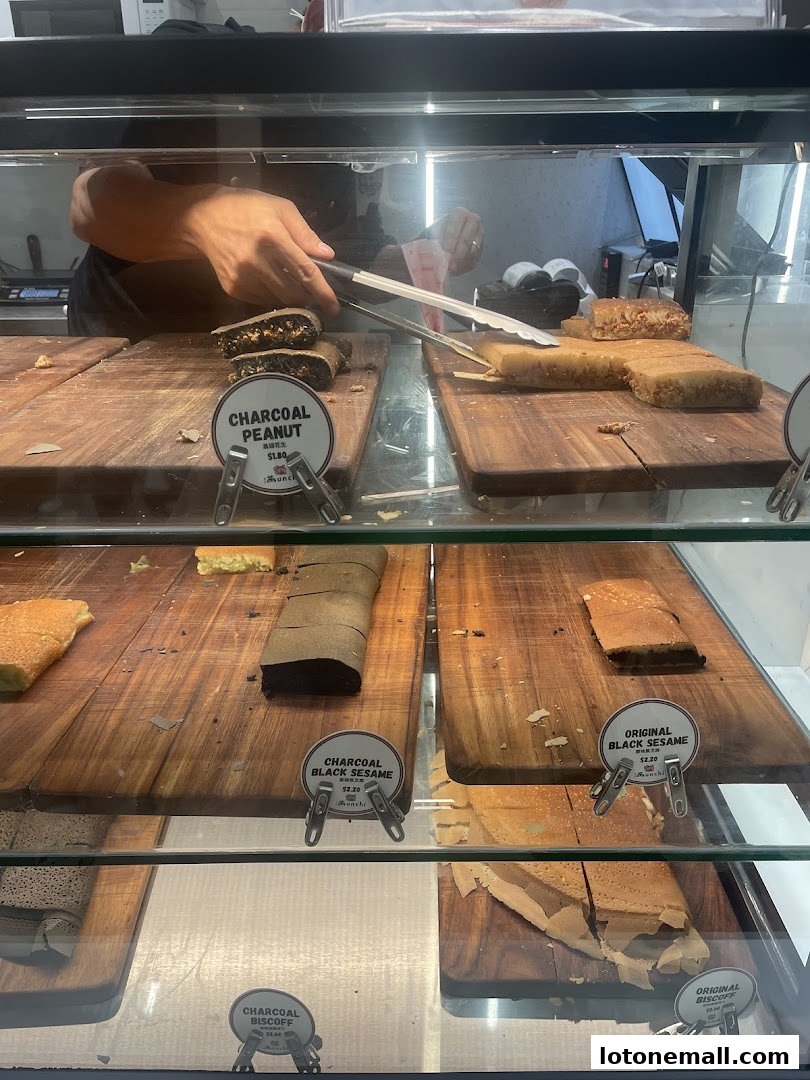 A display case filled with various flavors of pancakes, with a server's hands visible.