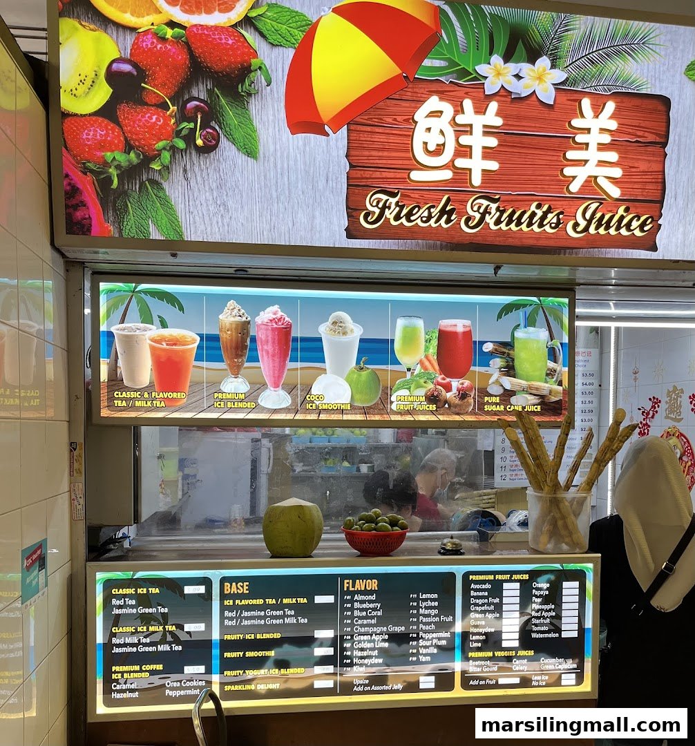 A vibrant fresh fruit juice shop with a detailed menu board and colorful signage.