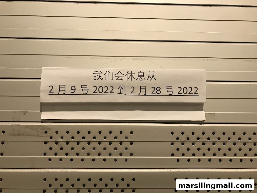 A temporary closure notice displayed on the closed roller shutter of Ah Yi Handmade Noodle Fish Soup.