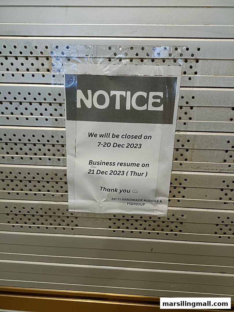 A notice on a closed shop shutter for Ah Yi Handmade Noodle Fish Soup, detailing temporary closure dates.