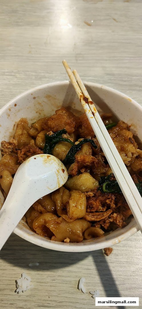 A close-up of a delicious bowl of handmade noodles with various toppings, a spoon, and chopsticks.