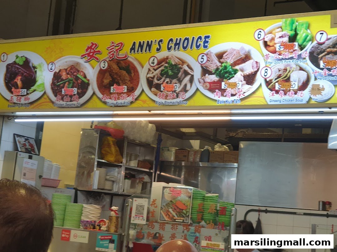 A vibrant menu board displays various traditional Asian dishes and soups at Ann's Choice food stall.