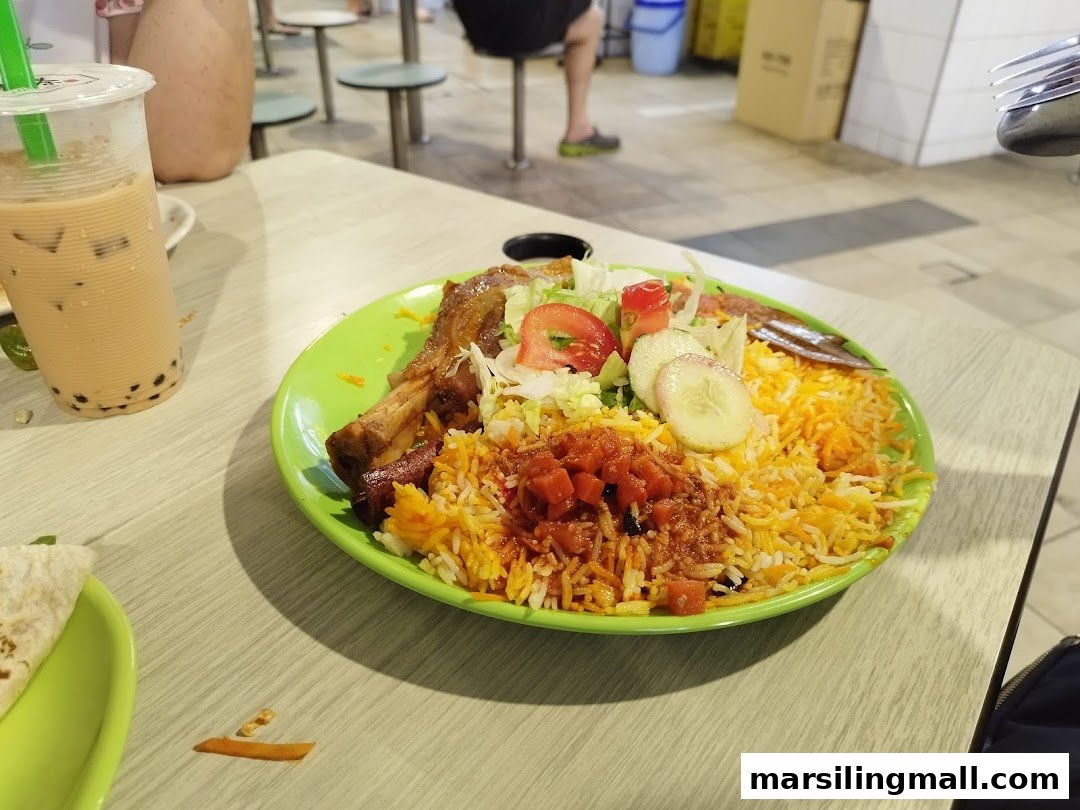 A vibrant plate of biryani with meat and salad, accompanied by a refreshing bubble tea.
