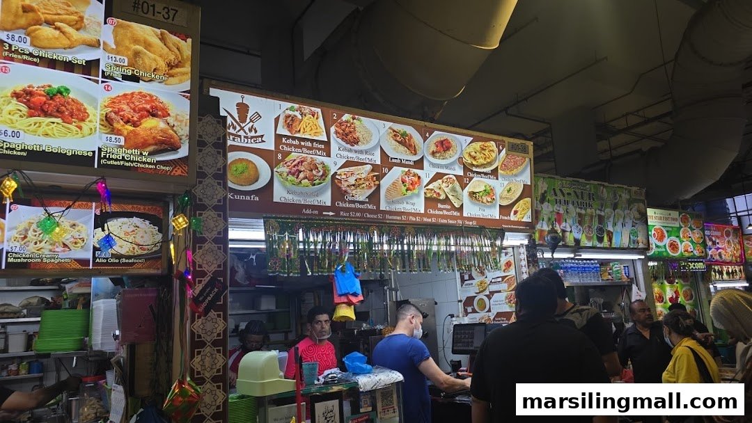 A bustling food stall featuring extensive menu boards with Middle Eastern kebabs, Western dishes, and more.