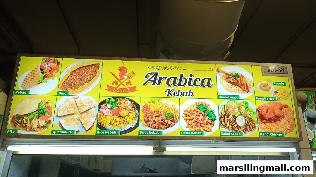 A brightly lit menu board for Arabica Kebab, showcasing various Middle Eastern and kebab dishes with images.